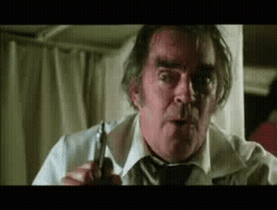 An Older Man In A White Shirt And Tie Is Holding A Pair Of Scissors . GIF