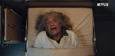 An Older Man Is Laying In A Hospital Bed With A Netflix Logo Behind Him GIF