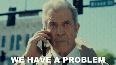 An Older Man Talking On A Cell Phone With The Words We Have A Problem Behind Him GIF