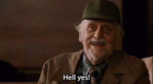 An Older Man Wearing A Hat And Tie Is Smiling And Saying Hell Yes . GIF