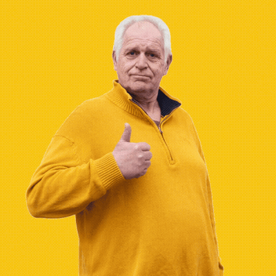 An Older Man Wearing A Yellow Sweater Gives A Thumbs Up GIF
