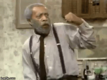 An Older Man With A Beard And Suspenders Is Making A Fist . GIF