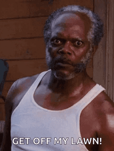 An Older Man With A Beard Is Wearing A White Tank Top And Saying Get Off My Lawn . GIF