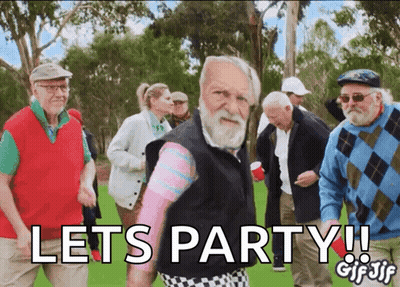 An Older Man With A Beard Stands In Front Of A Group Of Older People And Says Lets Party GIF