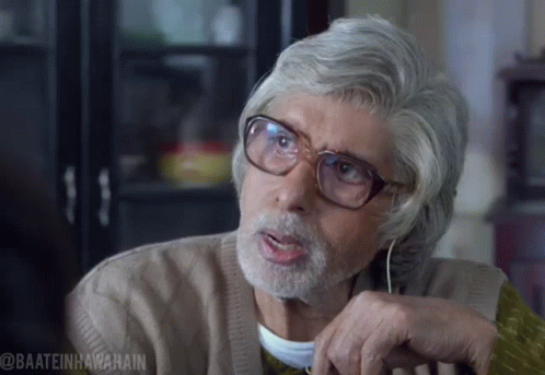 An Older Man With Glasses And A Beard Has The Hashtag @Baateinhawaain On The Bottom Right GIF