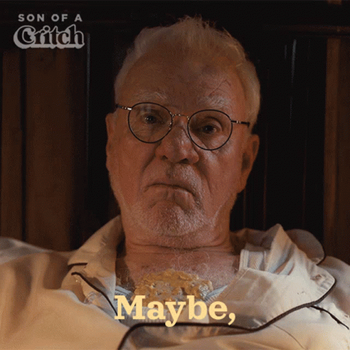 An Older Man With Glasses Is Laying In Bed With The Words Maybe On The Bottom Right GIF
