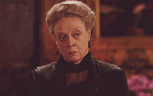 An Older Woman In A Black Dress Is Being Shown On Tv 1 Hd GIF