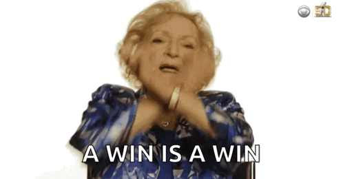 An Older Woman In A Blue Jacket Is Saying A Win Is A Win GIF
