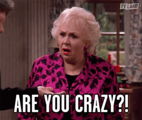 An Older Woman In A Pink Jacket Is Asking If She Is Crazy GIF