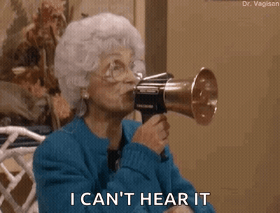 An Older Woman Is Holding A Megaphone In Her Mouth And Says I Can 'T Hear It . GIF