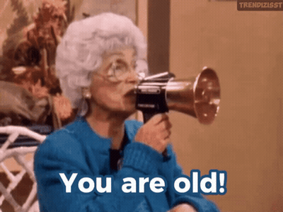 An Older Woman Is Holding A Megaphone In Her Mouth And Says You Are Old GIF