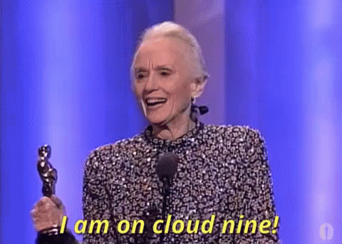 An Older Woman Is Holding An Oscar Statue On A Stage And Saying `` I Am On Cloud Nine ! '' GIF