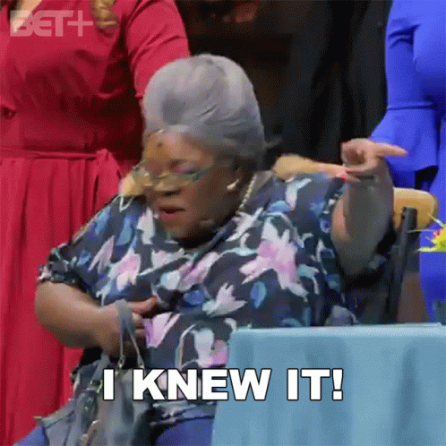 An Older Woman Is Sitting At A Table And Says I Knew It . GIF