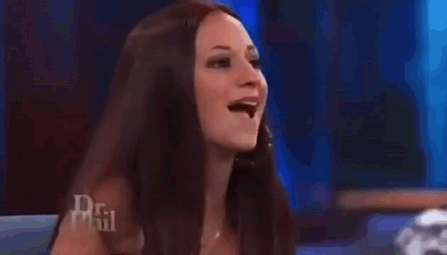 An Older Woman Is Sitting In Front Of A Crowd On A Television Show . GIF