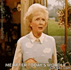 An Older Woman Is Standing In Front Of A Window And Talking To Someone . GIF