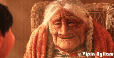 An Older Woman Sitting In A Wicker Chair With The Name Vipin Ayilam On The Bottom GIF