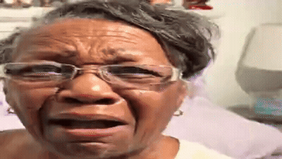 An Older Woman Wearing Glasses Is Crying And Making A Funny Face . GIF