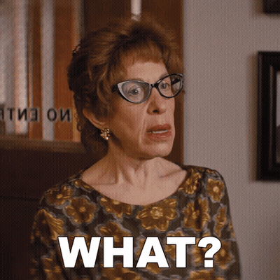 An Older Woman Wearing Glasses Says What GIF