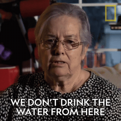 An Older Woman With Glasses Says We Don 'T Drink The Water From Here GIF