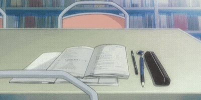 An Open Book Is On A Desk With A Pen And Pencil Case GIF