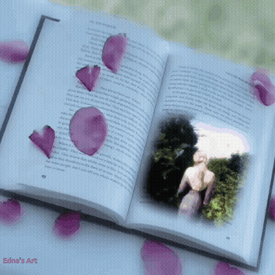 An Open Book With A Picture Of A Woman And Petals Falling From It GIF