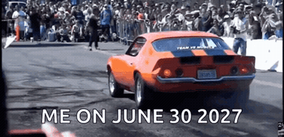 An Orange Car Is Driving Down A Race Track With The Words Me On June 30 2027 Written On The Bottom GIF