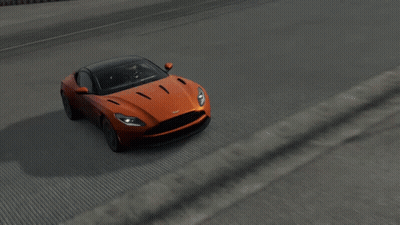An Orange Car With A Black Roof Is Driving On A Road GIF