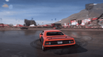 An Orange Car With A California License Plate Is Driving On A Race Track GIF