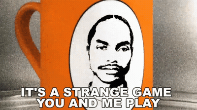 an orange coffee mug with a picture of a man and the words it 's a strange game you and me play