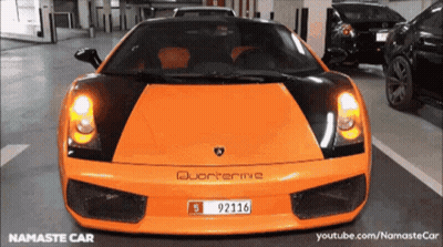 An Orange Sports Car With A License Plate That Reads 92116. GIF