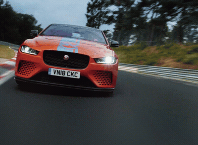 An Orange Sports Car With The License Plate Vni8 Ckc GIF