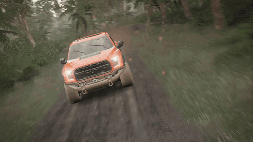 An Orange Truck Is Driving Down A Muddy Road GIF