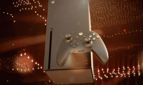 An Xbox Controller Is Sitting Next To A Box GIF