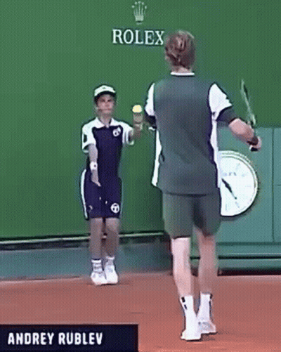 Andrey Rublev Is Playing Tennis In Front Of A Rolex Banner GIF