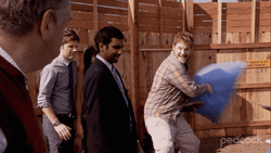 Andy Dwyer Hitting A Man With Stuffed Sack GIF
