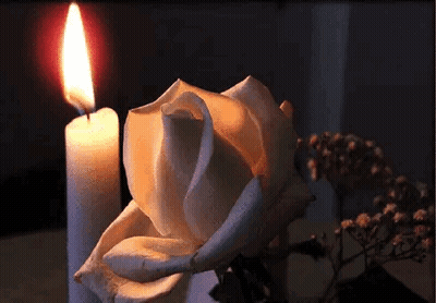 Angel Statue Next To Red Heart With Candle GIF