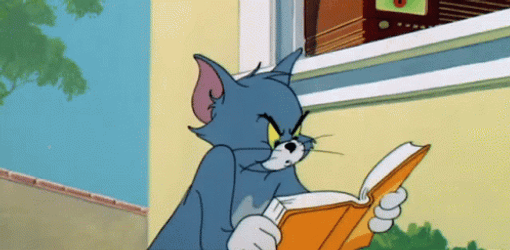 Angry Tom Cat Reading Book GIF