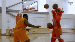 Anthony Adams With A Joggling Mascot GIF
