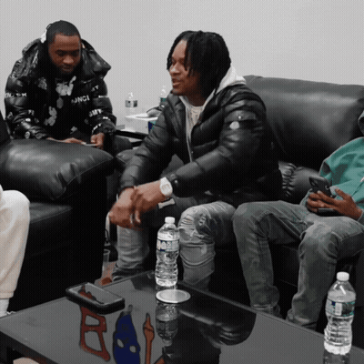 Aquafina Water Bottle On Table Beside Men GIF