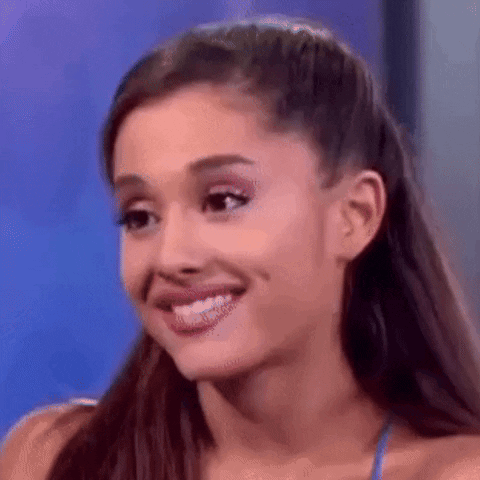 Ariana Grande Is Smiling And Making A Funny Face While Talking On A Television Show . GIF