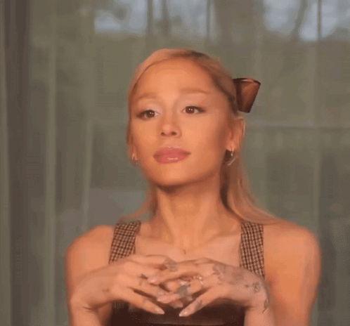 Ariana Grande Is Wearing A Butterfly Clip In Her Hair And Has A Tattoo On Her Wrist . GIF