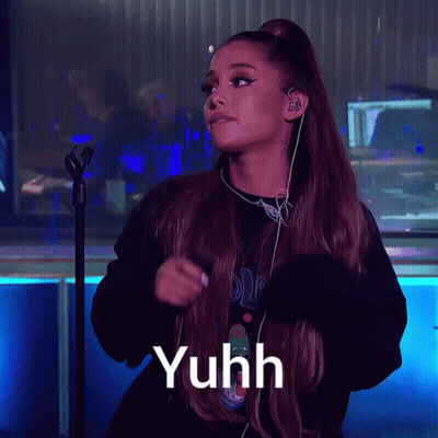 Ariana Grande Singing Into A Microphone With The Word Yuhh Written Below Her GIF