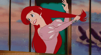 Ariel From The Little Mermaid Is Brushing Her Hair With A Comb GIF