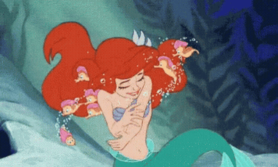 Ariel From The Little Mermaid Is Hugging A Group Of Little Mermaids In The Ocean . GIF