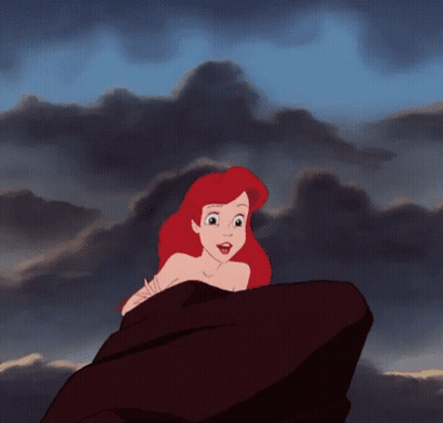 Ariel From The Little Mermaid Is Sitting On A Rock Looking At The Sky . GIF
