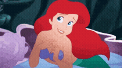 Ariel From The Little Mermaid Is Smiling While Swimming In The Ocean GIF