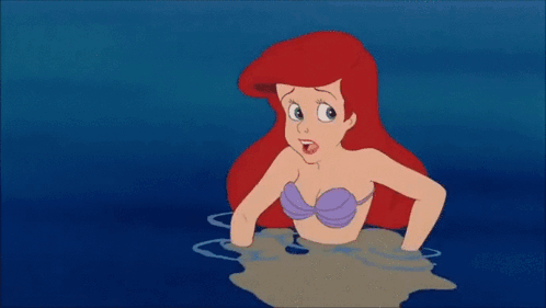 Ariel From The Little Mermaid Is Swimming In The Ocean Next To A Yellow Fish GIF