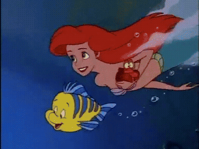 Ariel From The Little Mermaid Is Swimming With A Yellow Fish . GIF
