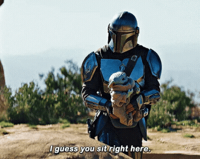 Armored Man Holding Baby Says I Guess You Sit Right Here GIF