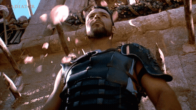 Armored Man In Front Of Wall With Word Gladiator GIF